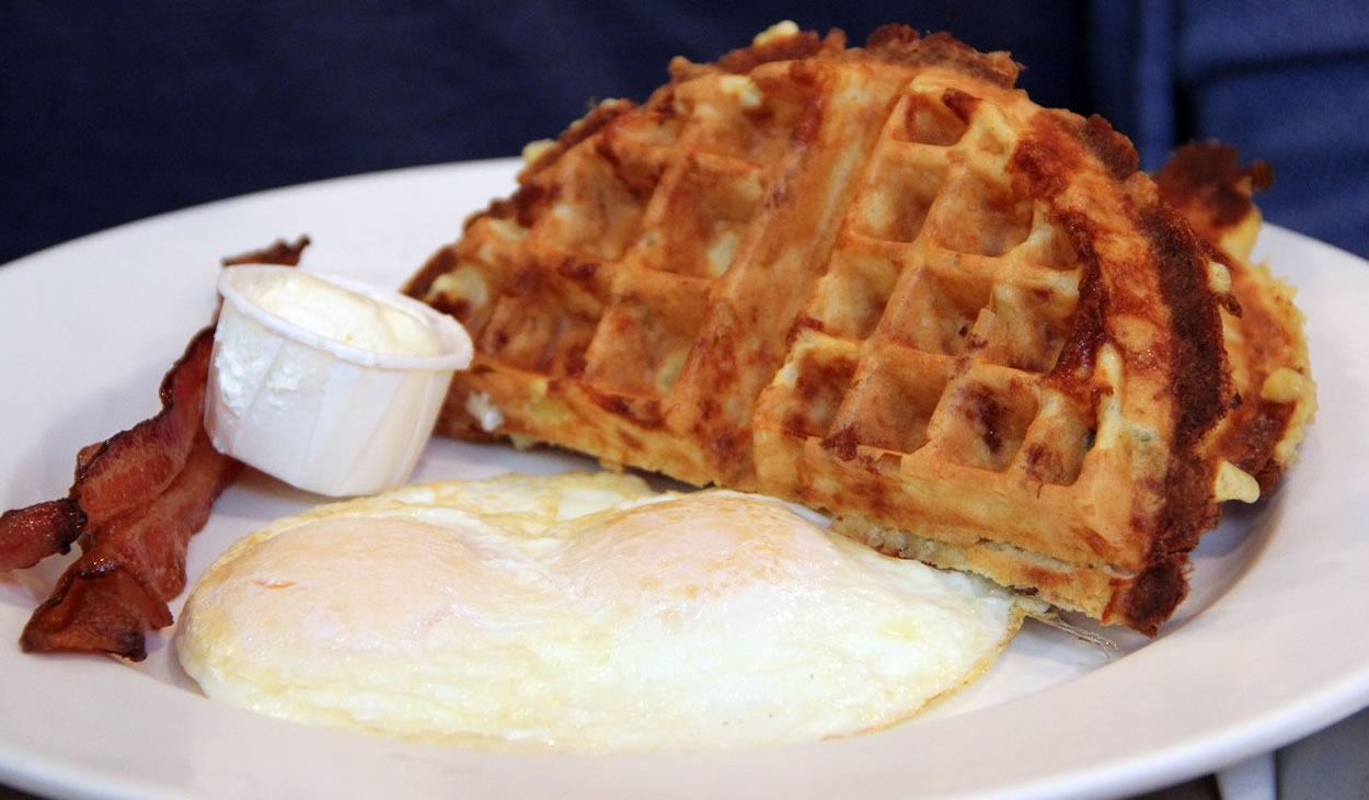 Fairway breakfast special: cheddar scallion Belgian waffle with two eggs over-easy and a side of bacon