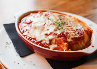 Baked lasagna: house made pasta layered with spicy sausage, ground beef, ricotta and mozzarella